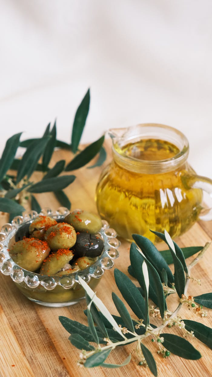 A rustic display of olives with olive oil, perfect for Mediterranean dining themes.